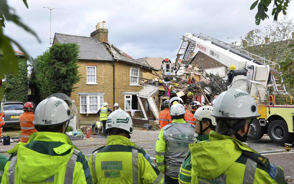 Emergency services work at the scene of a fallen tree at Bath Road in Hounslow, west London October 28, 2013. Britain's strongest storm in a decade battered southern regions on Monday, forcing hundreds of flight cancellations, cutting power lines and disrupting the travel plans of millions of commuters. Winds of up to 99 miles per hour (160 km per hour) lashed southern England and Wales in the early hours of Monday, shutting down rail services in some areas during rush hour. (REUTERS/Toby Melville)