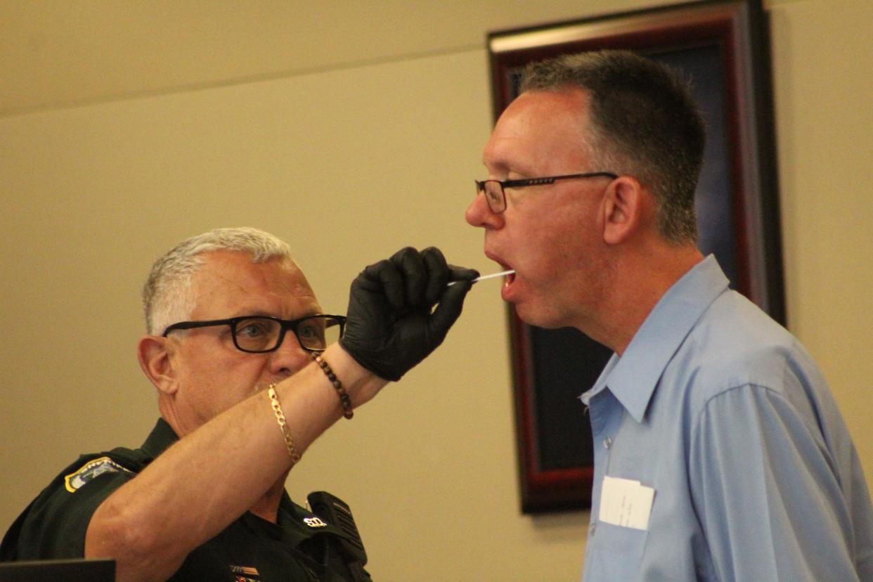 A bailiff takes a DNA sample from Robert Orr, who was the ex-president of the Las Brisas condominium association near Marineland. Orr was sentenced to two years in prison for secretly videotaping a woman.
(Photo: Frank Fernandez)