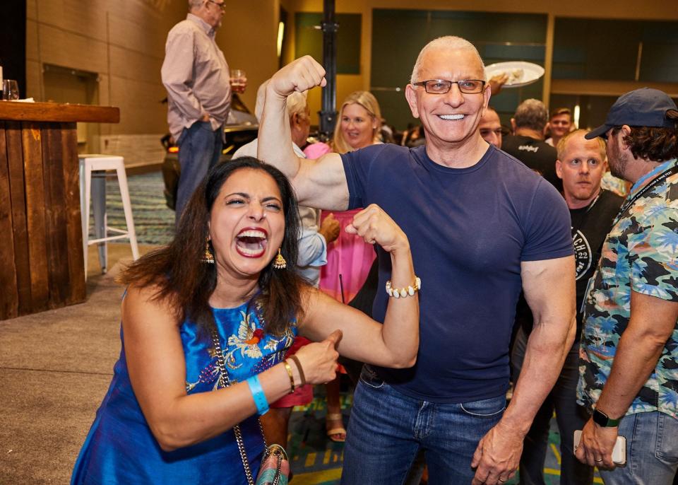 Food Network star chefs Robert Irvine, right, and Maneet Chauhan strike a pose during the 2022 Palm Beach Food & Wine Festival's Grand Tasting event.