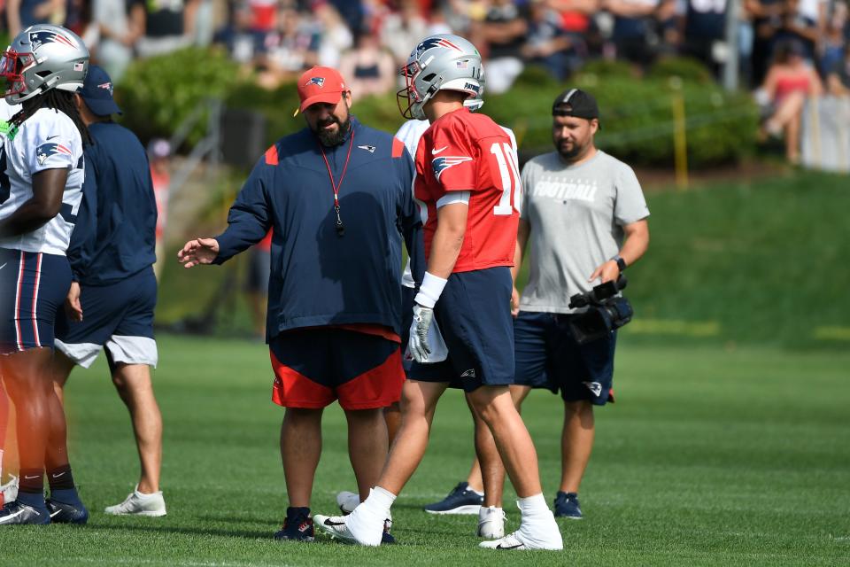 Assistant coach Matt Patricia makes a point with quarterback Mac Jones during practice on July 30.