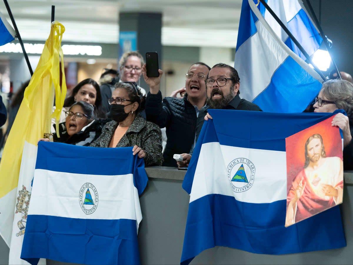 Supporters of Nicaraguan political prisoners chant at Washington Dulles International Airport ahead of their arrival on Thursday 9 February 2023 (Jose Luis Magana/AP)