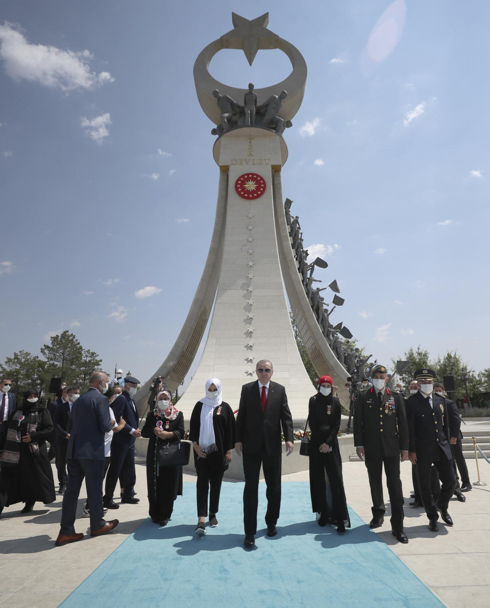 Turkey's President Recep Tayyip Erdogan and family members of coup victims leave the "Martyrs Monument" outside his presidential palace, in Ankara, Turkey, Wednesday, July 15, 2020. Turkey is marking the fourth anniversary of the July 15 failed coup attempt against the government, with prayers and other events remembering its victims.(Turkish Presidency via AP, Pool) in Ankara, Turkey, Tuesday, July 15, 2020.(Turkish Presidency via AP, Pool)