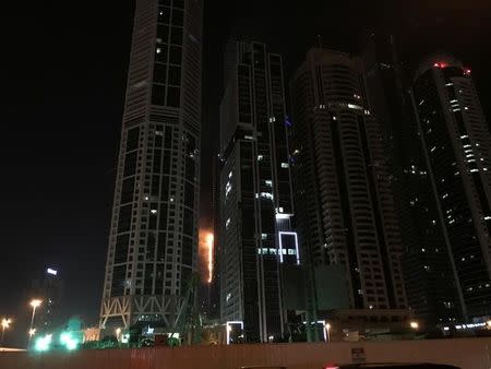 Flames shoot up the side of the Torch tower residential building in the Marina district, Dubai, United Arab Emirates, August 4, 2017. REUTERS/Abed Al Hadi Al Ramahi