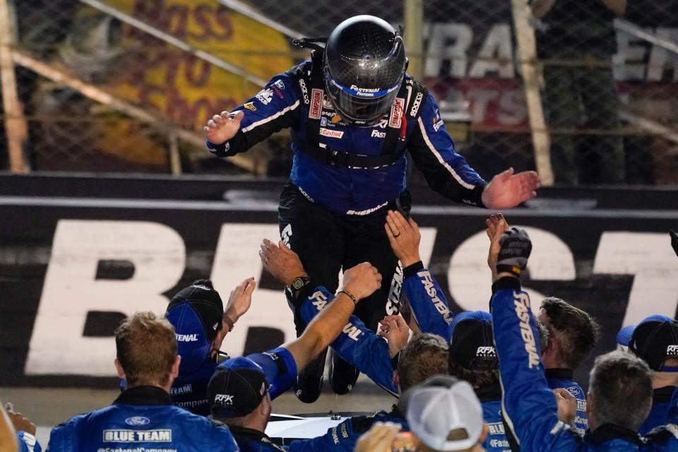 Chris Buescher jumps from the top of his car to the arms of his crew after winning a NASCAR Cup Series auto race at Bristol Motor Speedway Saturday, Sept. 17, 2022, in Bristol, Tenn. (AP Photo/Mark Humphrey)