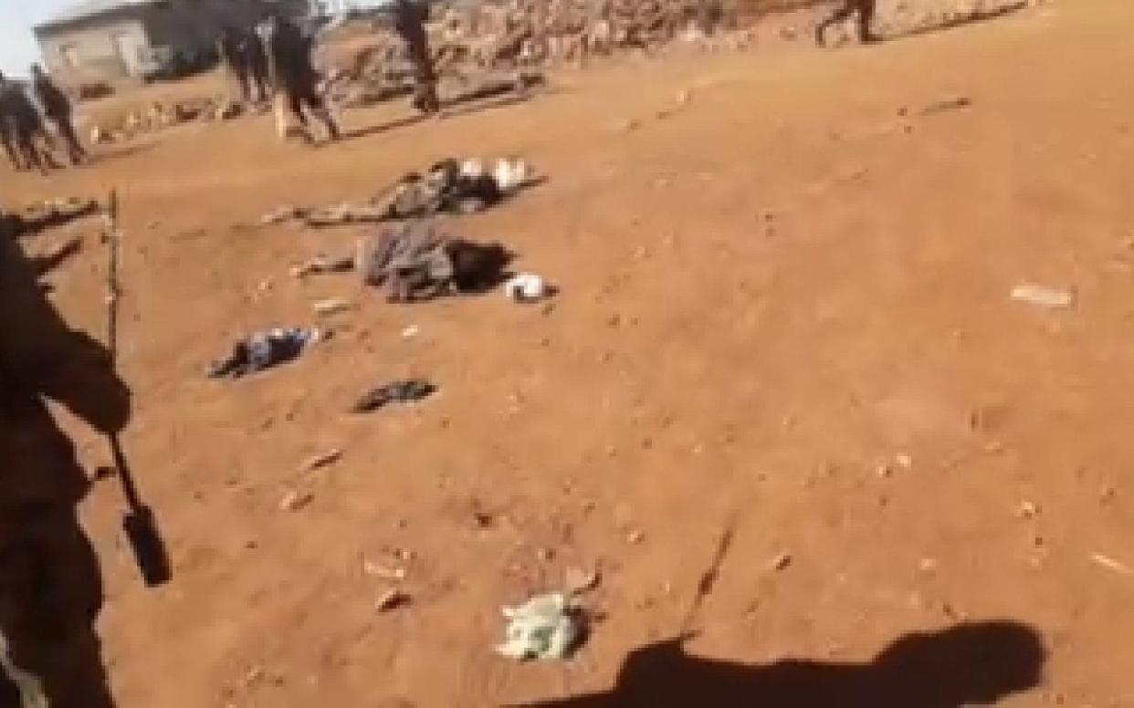 Ethiopian soldiers walk among the bodies of dozens of recently-killed Tigrayan villagers in Debre Abay monastery. The full footage is too graphic to publish. - The Telegraph / screengrab