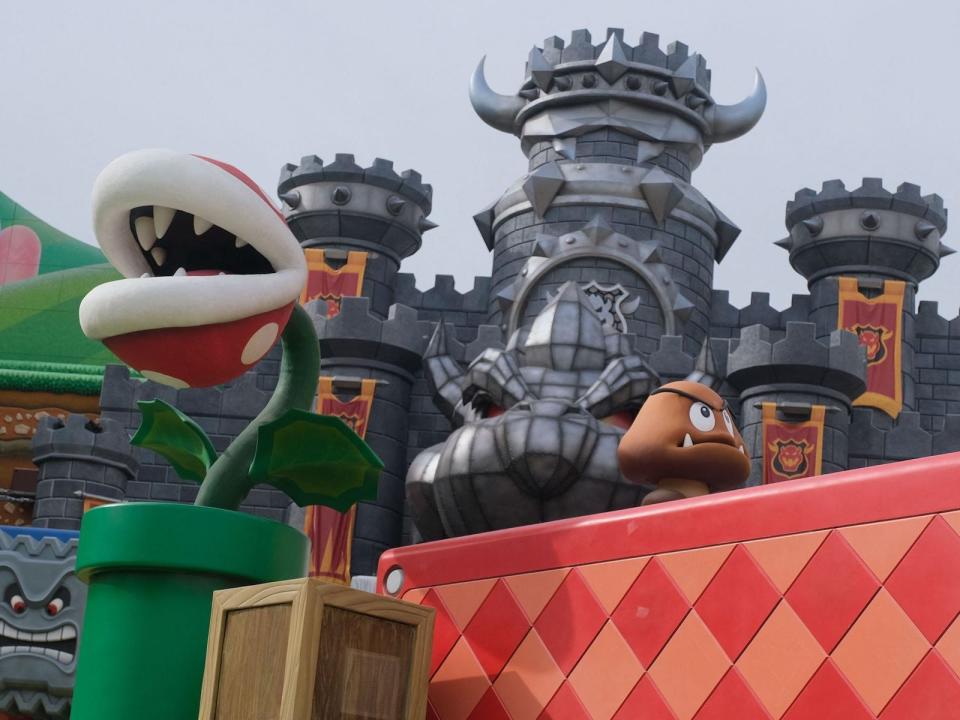 A Goomba and a piranha plant patrol the walls during a preview of Super Nintendo World at Universal Studios in Los Angeles, California, on January 13, 2023.