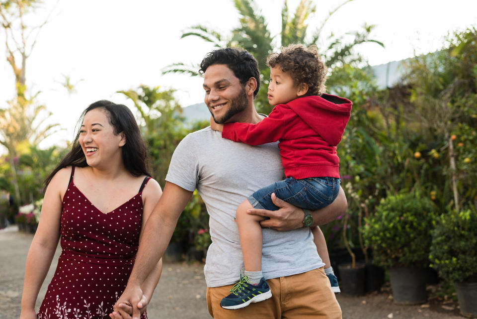 Young couple walking with their toddler son