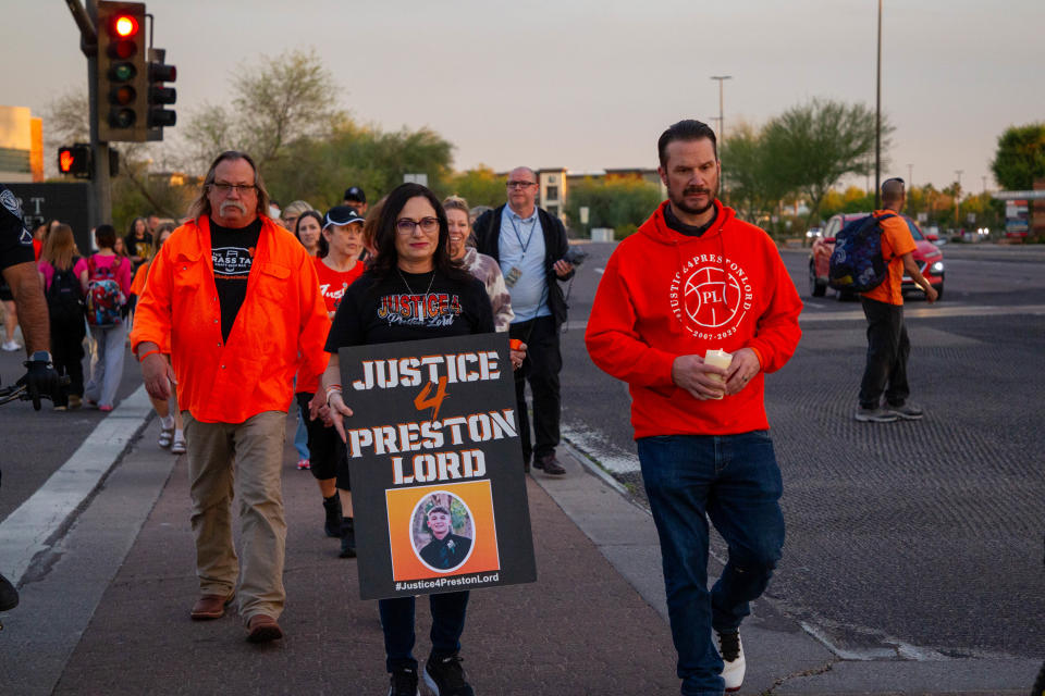 Preston Lord's grandfather Tony Reich (from left), stepmother Melissa Ciconte and father Nick Lord walk in Gilbert during a Light the Night walk for Preston Lord on March 28, 2024.