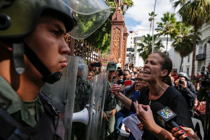 Venezuelan opposition lawmaker Manuela Bolivar confronts members of the security forces at the National Assembly building in Caracas