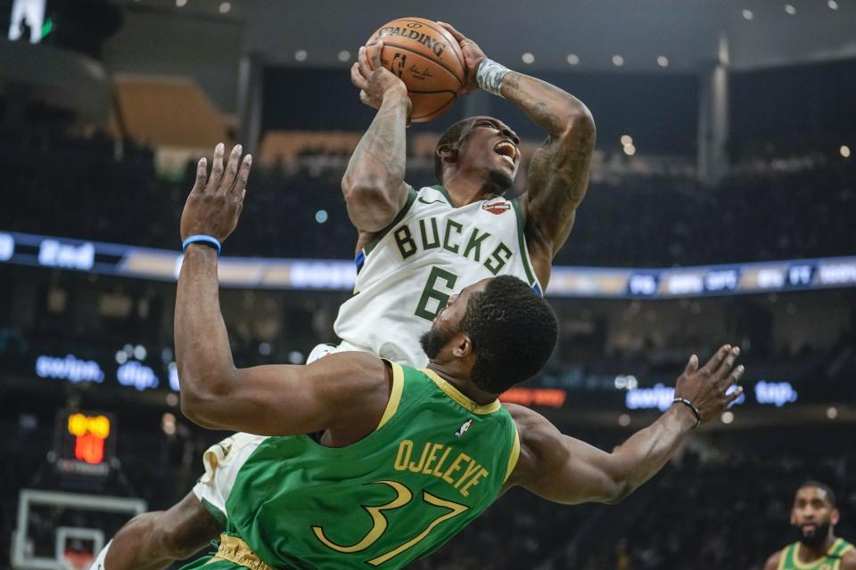 Milwaukee Bucks' Eric Bledsoe is fouled by Boston Celtics' Semi Ojeleye during the first half of an NBA basketball game Thursday, Jan. 16, 2020, in Milwaukee. (AP Photo/Morry Gash)