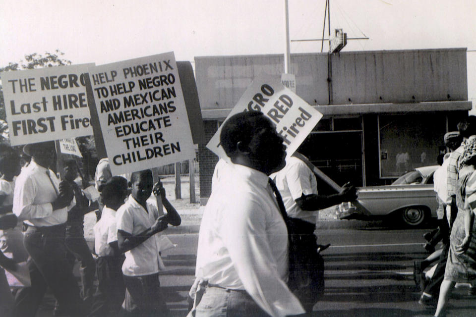In this 1962 photo, Civil Rights leader Lincoln Ragsdale and supporters march on the Arizona state capitol for the desegregation of public places with the public accommodation bill prior to the Civil Rights Act of 1964. Phoenix’s past segregation has been in focus after last month’s national outrage over a videotaped encounter of police pointing guns and cursing at a black family. (Lincoln Ragsdale Jr/Matthew Whitaker Photographs, University Archives, Arizona State University Library via AP)
