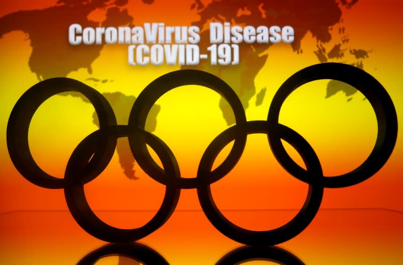 A 3D printed Olympics logo is seen in front of displayed world map and "Coronavirus Disease (COVID-19)" words in this illustration
