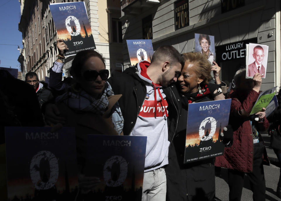 Sex abuse survivor Alessandro Battaglia, left, is hugged by survivor and founding member of the ECA (Ending Clergy Abuse), Denise Buchanan, during a march in Rome, Saturday, Feb. 23, 2019. Pope Francis is hosting a four-day summit on preventing clergy sexual abuse, a high-stakes meeting designed to impress on Catholic bishops around the world that the problem is global and that there are consequences if they cover it up. (AP Photo/Alessandra Tarantino)