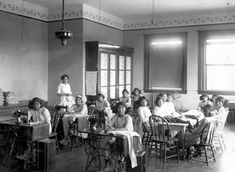 Undated photo of a teacher and young female students seated with sewing machines in classroom at the Phoenix Indian Industrial School. / Credit: Walter J. Lubken/U.S. Bureau of Reclamation, Phoenix Area Office