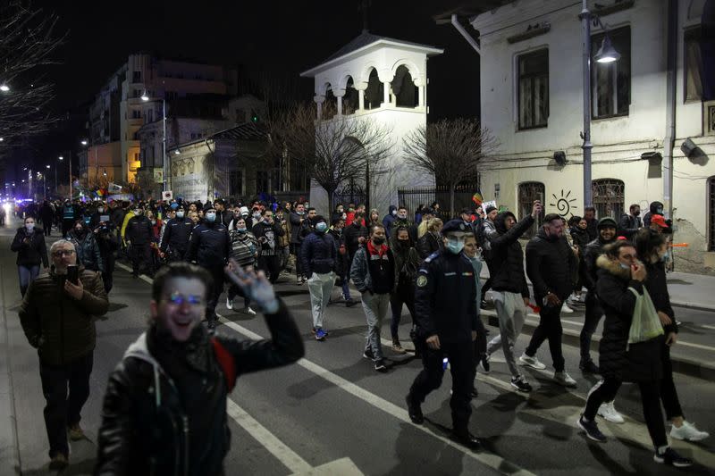 People march in downtown Bucharest demanding an end to COVID-19 restrictions