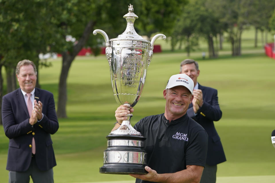 Alex Cejka holds the Alfred S. Bourne Trophy after winning the Senior PGA Championship golf tournament Sunday, May 30, 2021, in Tulsa, Okla. (AP Photo/Sue Ogrocki)