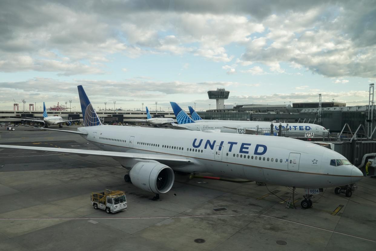 United Airlines planes wait at gates at Newark Liberty International Airport, Monday, Nov. 27, 2023, in Newark, N.J.