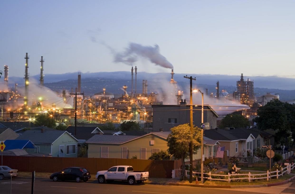 Smokestacks in the Los Angeles neighborhood of Wilmington. <span>Citizen of the Planet/Education Images/Universal Images Group via Getty Images</span>