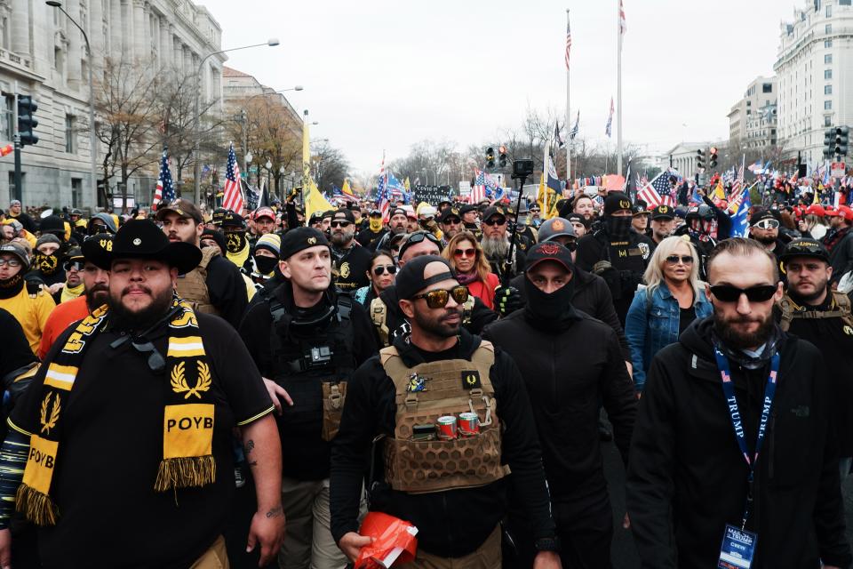 <p>Enrique Tarrio, centre, and members of the far-right Proud Boys led demonstrations in Washington DC on 12 December.</p> (EPA)