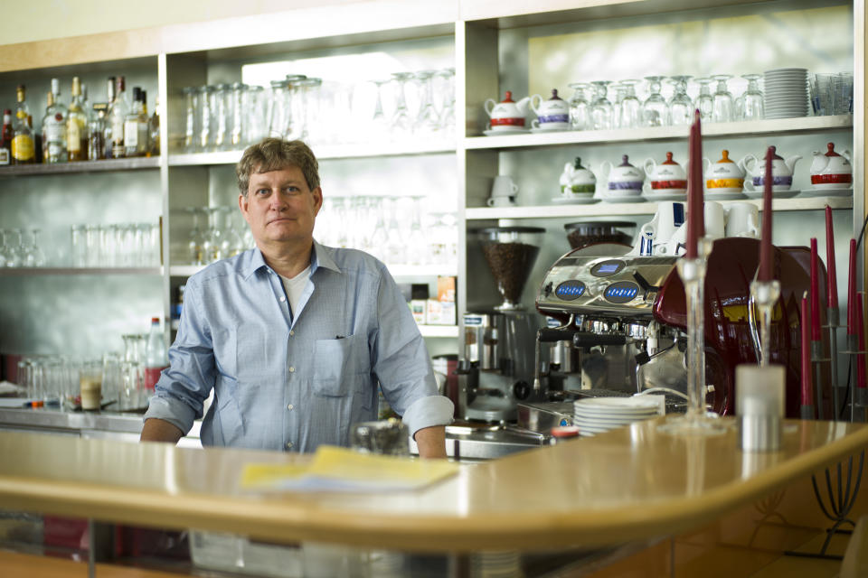 In this Tuesday, May 21, 2019 photo, Armin Doetsch owner of the restaurant Aennchen von Thorgau, poses for a photo during an interview with the Associated Press in Berlin. Armin Doetsch participates in a food sharing program via the App 'Too Good To Go' for ecological reasons. In Germany, growing numbers of people use modern technology such as phone apps to help reduce food waste. In an effort to cut down on climate-wrecking carbon dioxide emissions created by food waste, they build online communities to share food before throwing it away. (AP Photo/Markus Schreiber)