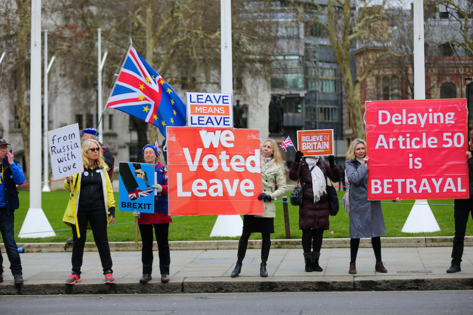 Pro-Brexit demonstrators with banners, placards and flags protesting outside the Houses of Parliament (Picture: PA)