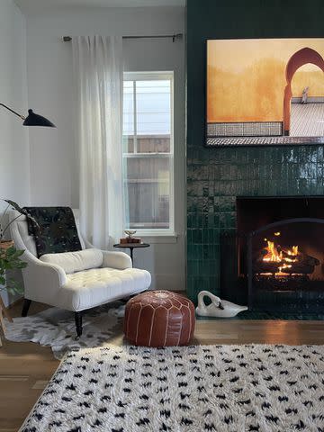 <p>Aubrey Butcher</p> Green zellige tile fireplace in Butcher's living room