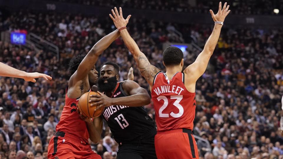 Dec 5, 2019; Toronto, Ontario, CAN; Houston Rockets guard James Harden (13) drives between Toronto Raptors forward OG Anunoby (3) and guard Fred VanVleet (23) during the first half at Scotiabank Arena. Mandatory Credit: John E. Sokolowski-USA TODAY Sports