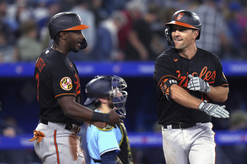 Baltimore Orioles' Adam Frazier, right, celebrates his two-run home run against the Toronto Blue Jays with Jorge Mateo during the ninth inning of a baseball game Friday, May 19, 2023, in Toronto. (Chris Young/The Canadian Press via AP)