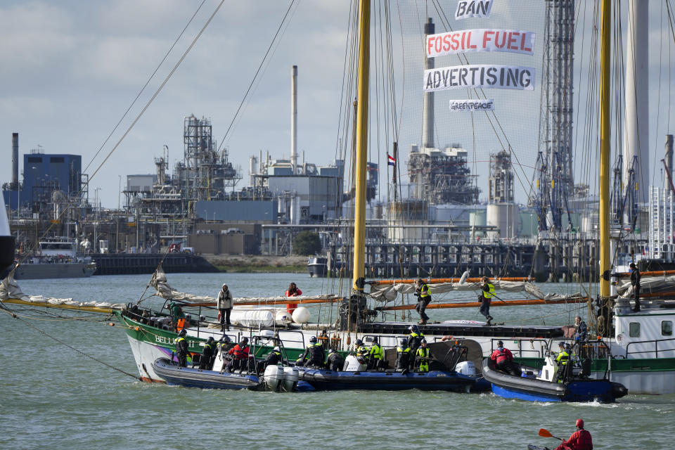 FILE- In this Monday, Oct. 4, 2021, file photo, Dutch riot police prepare to board Greenpeace's Beluga II when breaking up a protest by climate activists at a Shell refinery in Rotterdam, Netherlands. The Netherlands' biggest pension fund announced Tuesday Oct. 26, 2021, that it will stop investing in companies that produce fossil fuels, saying the move that has long been demanded by members of the fund was prompted by recent climate reports by the United Nations and International Energy Agency. (AP Photo/Peter Dejong)