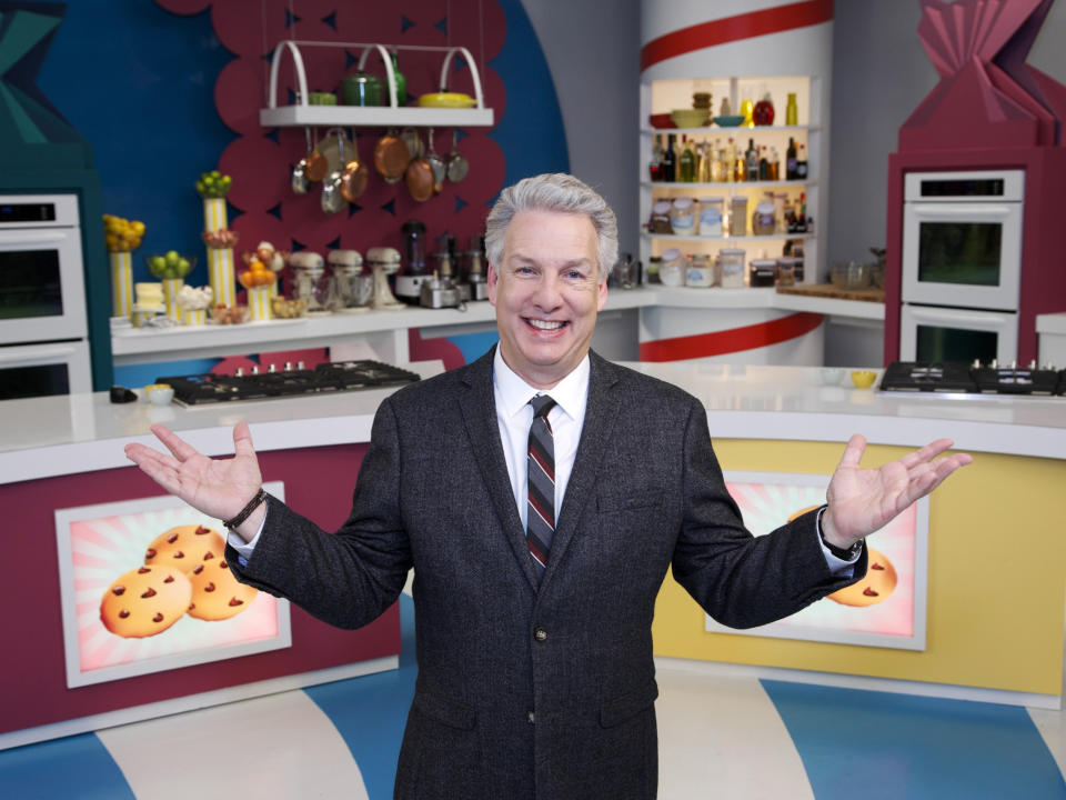 In this 2014 photo provided by the Food Network, judge and host, Marc Summers, poses for a portrait on set during the filming of Food Network's "Rewrapped," Season 1, in Montclair, N.J. The reality TV show is a cooking competition in which three chefs create their version of famous snacks. It debuts April 21, on Food Network with host Joey Fatone. (AP Photo/Food Network, Anders Krusberg)