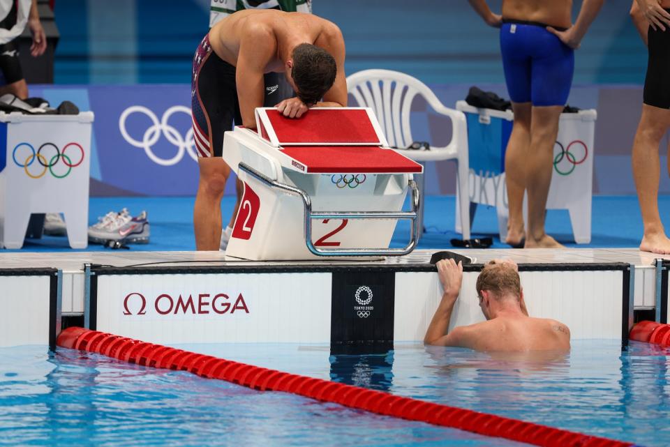 Zach Apple, top, and Haas Townley show exhaustion after the U.S. finished fourth in the men's 4x200 freestyle relay.