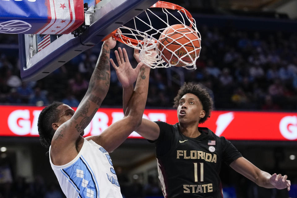 North Carolina forward Armando Bacot, left, dunks the ball in front of Florida State forward Baba Miller during the first half of an NCAA college basketball game in the quarterfinal round of the Atlantic Coast Conference tournament Thursday, March 14, 2024, in Washington.(AP Photo/Susan Walsh)