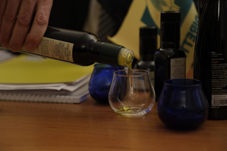 Coldiretti farm lobby olive oil expert Nicola Di Noia pours olive oil into a glass during an interview with the Associated Press in Rome, Wednesday, Feb. 15, 2017. From specialty shops in Rome to supermarkets around the world, fans of Italian olive oil are in for a surprise this year as prices are due to jump by as much as 20 percent. (AP Photo/Gregorio Borgia)