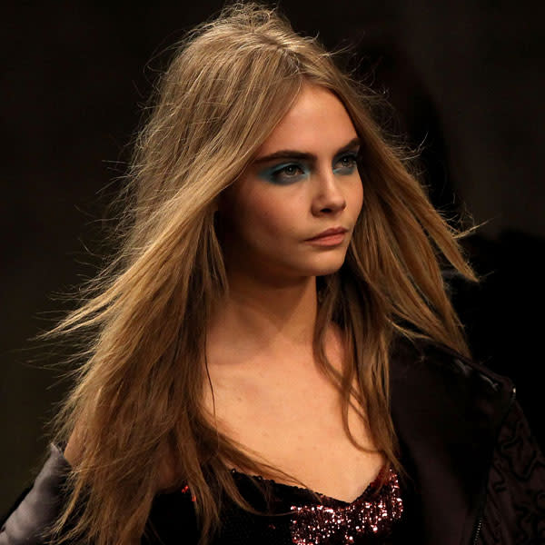 <b>Topshop Unique </b><br><br>Cara Delevingne sported vivid blue eyeshadow on the catwalk.<br><br>Image © Getty