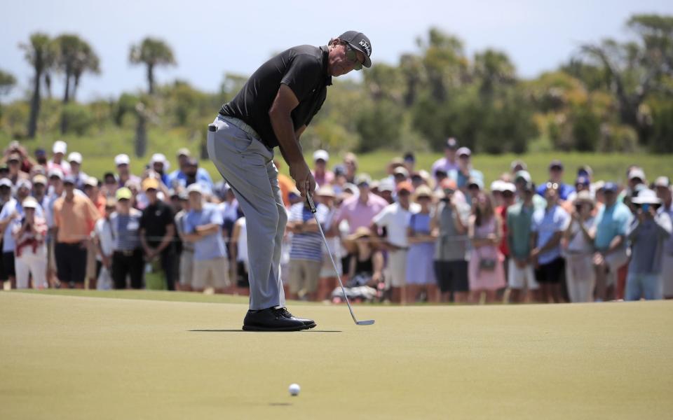 Phil Mickelson rolls in a putt - SHUTTERSTOCK