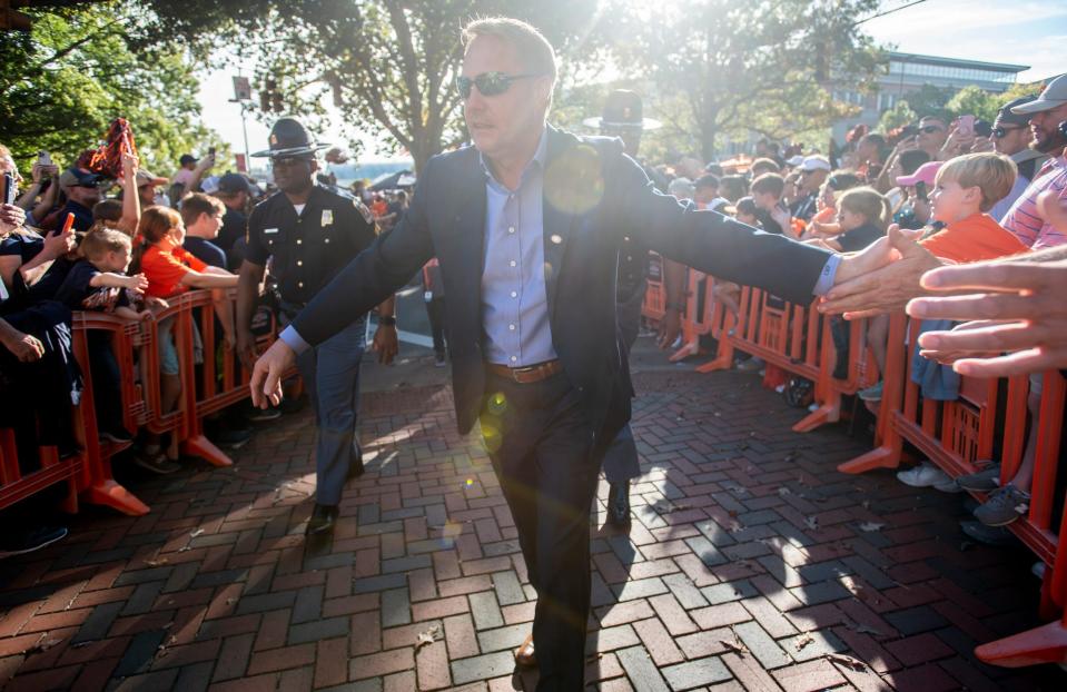 Current Auburn coach Hugh Freeze greets fans during Tiger Walk before the Tigers game against Mississippi, his former team, at Jordan-Hare Stadium in 2023.