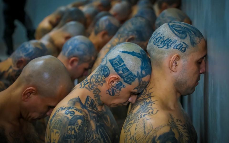 Gang members wait to be taken to their cells - AFP