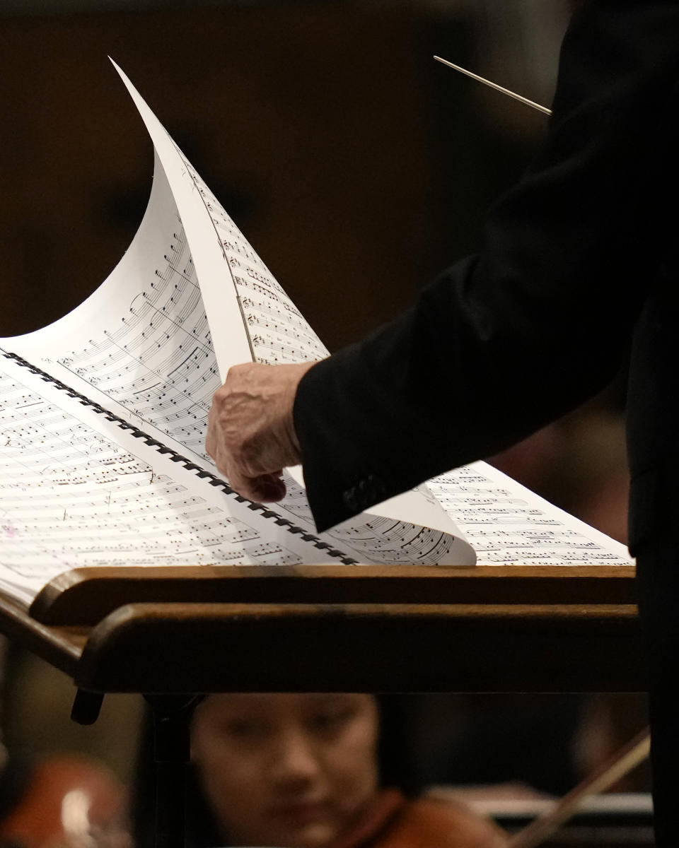 Riccardo Muti, musical director of the Chicago Symphony Orchestra turns a page of the score as he conducts the orchestra and chorus in Beethoven's "Missa Solemnis" in D Major, Op. 123, Sunday, June 25, 2023, in Chicago. Sunday marked the last performance by Muti, 81, in Orchestra Hall during his 13 year tenure. (AP Photo/Charles Rex Arbogast)