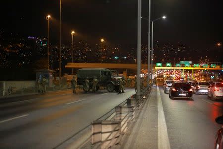 Turkish military block access to the Bosphorus bridge, which links the city's European and Asian sides, in Istanbul, Turkey, July 15, 2016. REUTERS/Stringer - RTSI72C