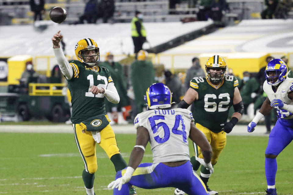 Green Bay Packers quarterback Aaron Rodgers (12) passes during the second half of an NFL divisional playoff football game against the Los Angeles Rams Saturday, Jan. 16, 2021, in Green Bay, Wis. (AP Photo/Mike Roemer)