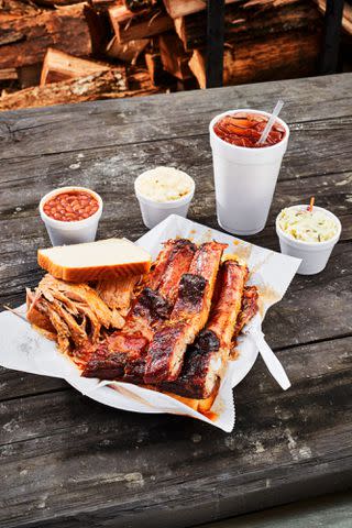 Robbie Caponetto Mix Plate of sliced pork and ribs with white bread at Archibald’s BBQ.