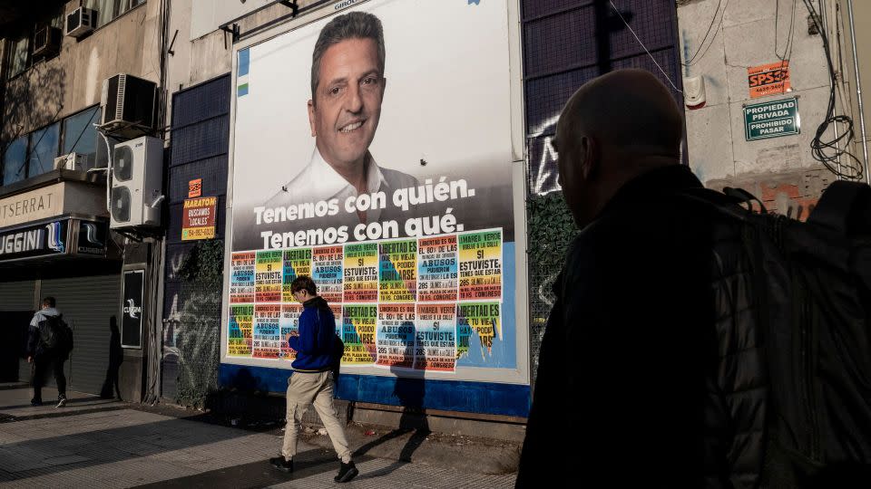 Pedestrians walk past a campaign poster for Sergio Massa, Argentina's economy minister and presidential candidate of Unity for the Homeland party in Buenos Aires on Sept. 29. - Anita Pouchard Serra/Bloomberg/Getty Images