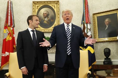 French President Emmanuel Macron (L) looks on as U.S. President Donald Trump speaks during their meeting in the Oval Office following the official arrival ceremony for Macron at the White House in Washington, U.S., April 24, 2018. REUTERS/Kevin Lamarque