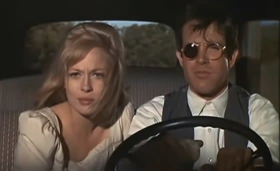 Bonnie and Clyde riding in a car together in "Bonnie and Clyde"