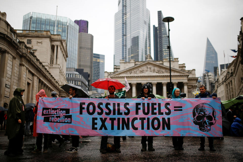 Protesters hold a banner as they block the road during an Extinction Rebellion demonstration at Bank, in the City of London, Britain October 14, 2019.  REUTERS/Henry Nicholls