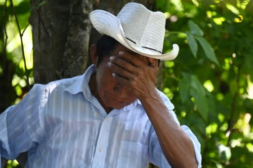Santos Perez Ortiz, 75, reacts as a forensic team exumes human remains, said to belong to his relatives killed in the 1981 El Mozote massacre