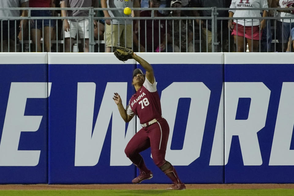 Oklahoma's Jocelyn Alo catches a fly ball hit for an out by Texas' JJ Smith during the seventh inning of the second game of the NCAA Women's College World Series softball championship series Thursday, June 9, 2022, in Oklahoma City. (AP Photo/Sue Ogrocki)