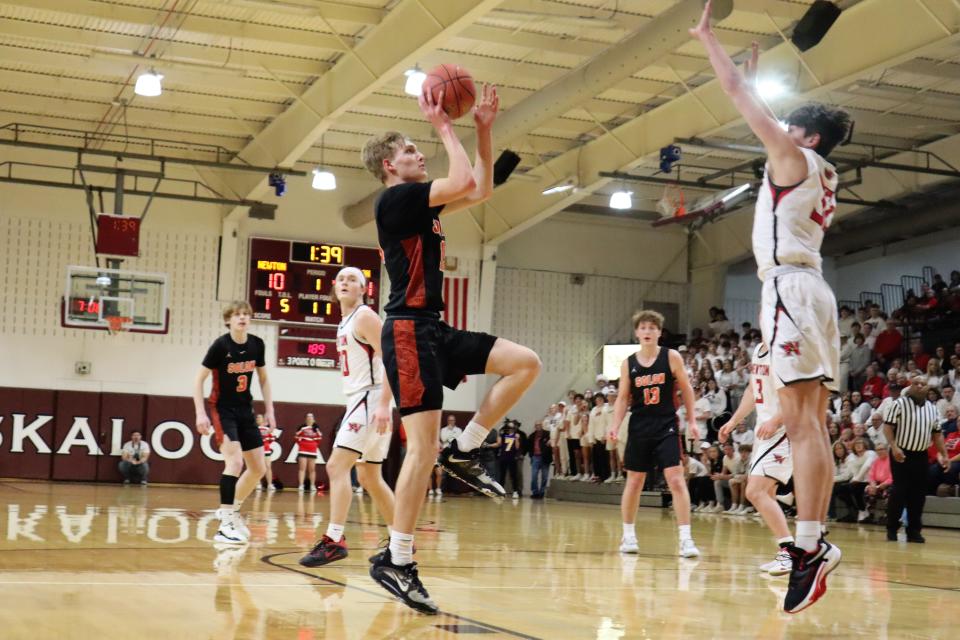 Solon's Jake Benzing attempting a floater against the Newton Cardinals.