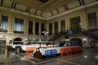 Tarps and fences block the seating area in the Hoboken Terminal waiting room in Hoboken, N.J., Tuesday, Oct. 27, 2020. Once a gleaming symbol of early 20th-century ambition and prosperity, the grand rail terminal now sits as a somber reminder of the daunting challenges facing mass transit in the New York region. (AP Photo/Seth Wenig)