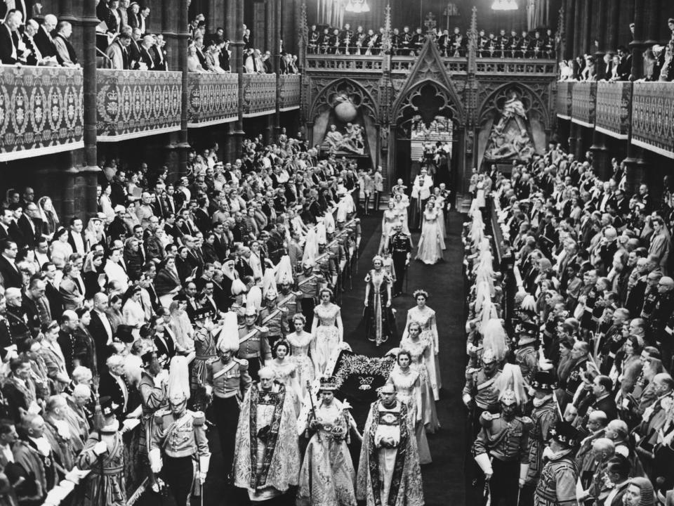 Queen Elizabeth II walks down the nave in Westminster Abbey after being crowned during her Coronation ceremony.